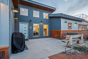 a blue house with a bench in front of it at Timber & Tin D 2Bed 2Bath w Pool & Rooftop Deck in Kanab