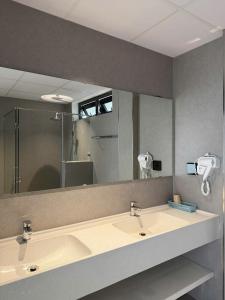 a bathroom with two sinks and a large mirror at Toàn Thịnh Hotel in Da Lat +55 photos