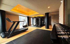 a fitness room with a gym with a treadmill at HOTELA Niseko Towers in Kutchan