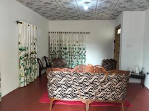 a room with a table with a zebra patterned table cloth at Ramanayaka Serenity Villa in Bandarawela