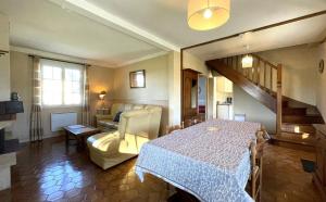a living room with a table and a couch at Sarthou in Espéchède
