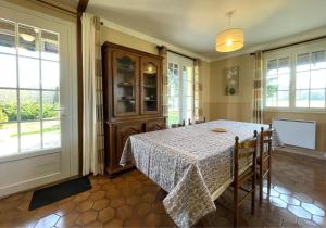 a dining room with a table and some windows at Sarthou in Espéchède