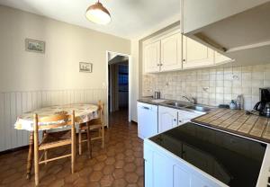 a kitchen with a table and a sink in it at Sarthou in Espéchède +34 photos