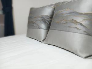 two pillows sitting on top of a bed at コーポラス十日市 - supported by COCOSTAY in Hiroshima