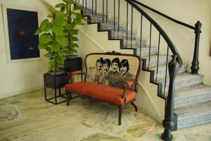 a room with a bench with a group of people on it at Ambiance Boutique Art Hotel Karachi in Karachi