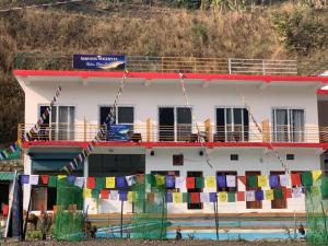a building with prayer flags on the side of it at Nirvana Maldevta in Dehradun