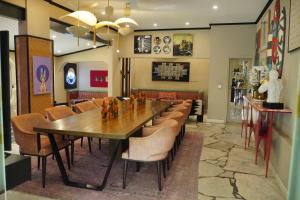 a dining room with a long table and chairs at Ambiance Boutique Art Hotel Karachi in Karachi +7 photos