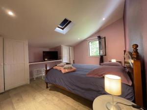 a bedroom with a bed and a tv and a table at Chez garcia in Urrugne