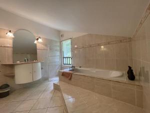 a large bathroom with a tub and a sink at Chez garcia in Urrugne