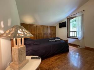 a bedroom with a bed and a table with a lamp at Chez garcia in Urrugne +21 photos
