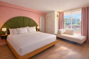 a large bedroom with a large bed and a window at Abode Beach House in Clearwater Beach