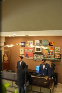 a group of men standing at a cash register at Ambiance Boutique Art Hotel Karachi in Karachi