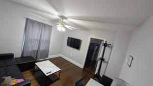 a living room with a couch and a ceiling fan at Cozy 1 Bedroom Bungalow in Charlotte