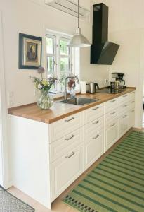 a kitchen with a sink and a counter top at Holiday Home At Fynshoved in Martofte