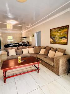a living room with a couch and a coffee table at Unogwaja Rest in Marloth Park