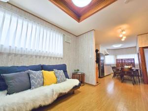 a living room with a blue couch with pillows on it at sora in Osaka