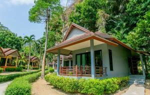a small green house with a brown roof at Tonsai Bay Resort in Tonsai Beach