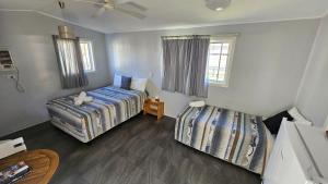 a bedroom with two beds and a window at Mitchell Motel & Cabins in Mitchell