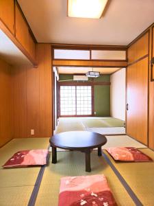 a room with a table and two red mats at sora in Osaka