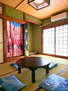 a room with a table in a room with windows at sora in Osaka