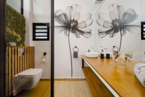 a bathroom with a counter with a toilet and a sink at La Fabrik' - Studio avec jacuzzi privé à La Réunion in Le Tampon