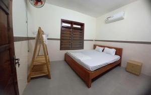 a bedroom with a bed and a ladder in it at Ngoc Lan Homestay in Tam Kỳ