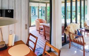 a room with a porch with a table and chairs at Sorbus in Rønne