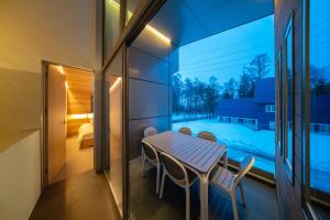 a balcony with a table and chairs and a bedroom at Eminence in Hakuba