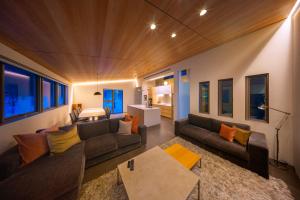 a living room with a couch and a table at Eminence in Hakuba