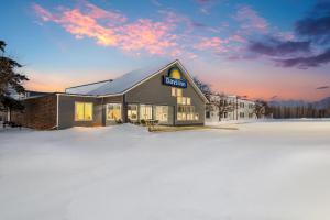 a building with a sign on it in the snow at Days Inn by Wyndham International Falls in International Falls