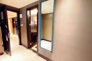 a mirror on the wall of a hallway at Ramada Plaza Tianlu Hotel in Wuhan