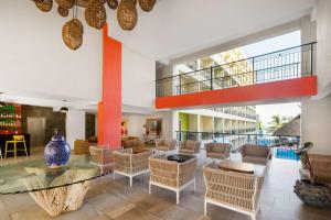 a lobby with a large glass table and chairs at Decameron Isla Coral Guayabitos, Ramada All-Inclusive Resort in Rincon de Guayabitos