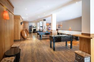 a room with two billiards tables and ping pong balls at KUHOTEL Steinplatte, Trademark Collection by Wyndham in Waidring