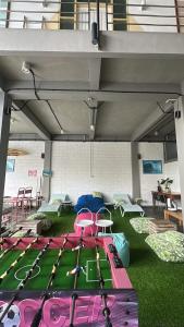 a play room with trampolines on the grass at Beach Hut Hostel in Kuta
