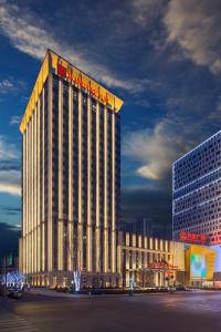 a large building with a sign on top of it at Wanda Realm Dandong in Dandong