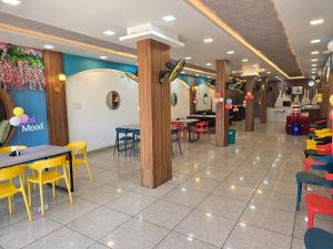 a dining room with tables and chairs in a restaurant at SHRI DIVYAM Hotel & Restaurant in Bhopal