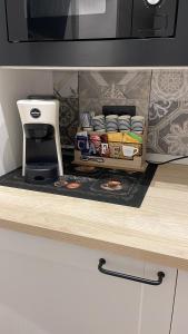 a kitchen counter with a coffee maker and a microwave at Casa Rebocco in La Spezia +9 photos