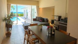 a kitchen and living room with a table and a living room at Feliz Villa Suite Miyakojima Ueno in Miyako-jima