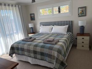 a bedroom with a bed with two towels on it at The Cottage at 105 in Redwoods Valley