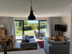 a living room with a couch and a tv and a table at The Cottage at 105 in Redwoods Valley