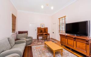 a living room with a large flat screen tv at Rosslyn in Grafton