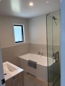 a bathroom with a tub and a sink and a shower at The Cottage at 105 in Redwoods Valley +8 photos