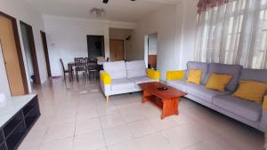 a living room with two couches and a coffee table at Green View Home Cameron Highlands in Brinchang