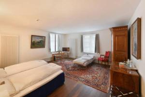 a bedroom with a bed and a living room at Hotel im Schlosspark in Basel