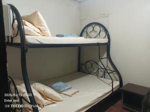 a bunk bed with a mattress and pillows on it at Little John's Town Inn in Coron +7 photos