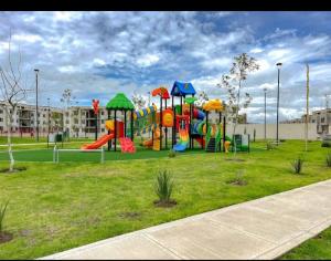 a playground with a slide in a park at Depto Moderno Cerca de AIFA estacionamiento wifi in Santa Cruz Tecamac