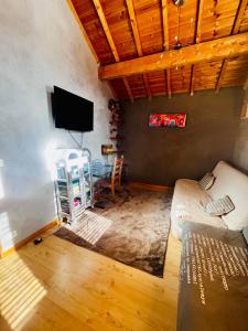 a living room with a couch and a flat screen tv at Comme à la maison à la montagne in Briançon