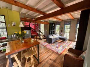 a living room with a table and a couch at Porcupine House in Magaliesburg