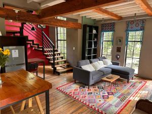 a living room with a couch and a table at Porcupine House in Magaliesburg