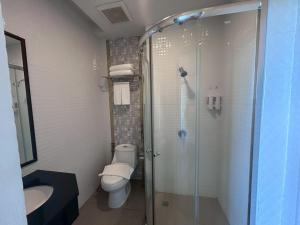 a bathroom with a shower and a toilet and a sink at Chiang Rai Airport Hotel in Ban Fang Min +22 photos